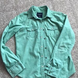 Pale green shirt with rivets.